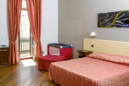 Ένα ή περισσότερα κρεβάτια σε δωμάτιο στο Hotel Medici