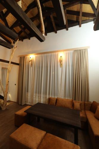 a living room with a couch and a table at Horlog Castle in Trigrad