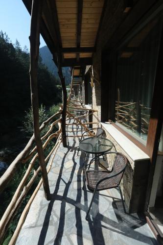 a patio with a table and chairs on a building at Horlog Castle in Trigrad