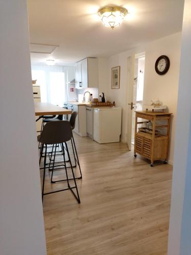 a kitchen with a table and chairs in a room at Naktakės apartamentai in Kupiškis
