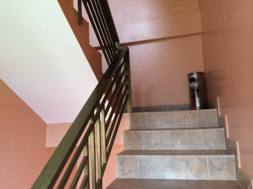a staircase in a house with a metal railing at Avocado Guesthouse in Senmonorom