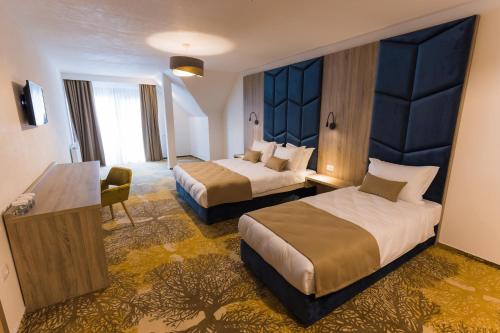 เตียงในห้องที่ Nedei Hotel&Spa Transalpina