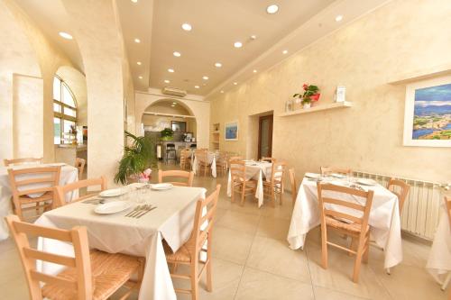 a restaurant with tables and chairs in a room at Albergo Atlantic in Ischia