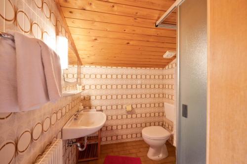 y baño con aseo blanco y lavamanos. en Grödnerhof Almöhi en Brie