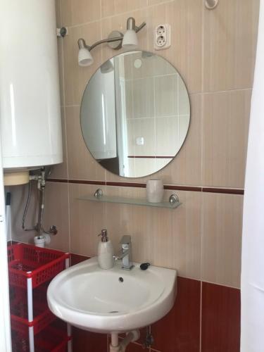 a bathroom with a sink and a mirror at Guest House Rózsakert in Egerszalók