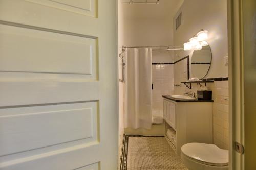 a bathroom with a toilet and a sink and a mirror at Menger Hotel in San Antonio