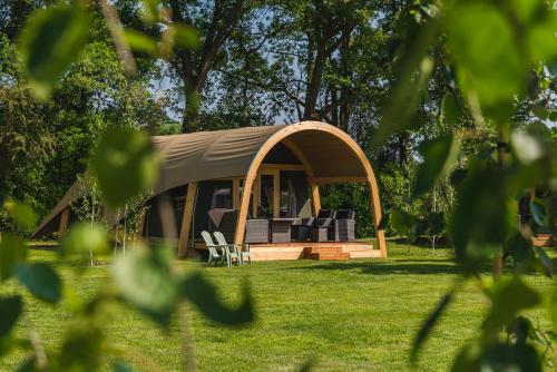 a gazebo with chairs and tables in a yard at Vakantiecentrum 't Schuttenbelt in Enter