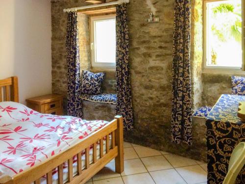 1 dormitorio con cama, mesa y ventanas en Val Rive - Degas Apartment, en Dinan