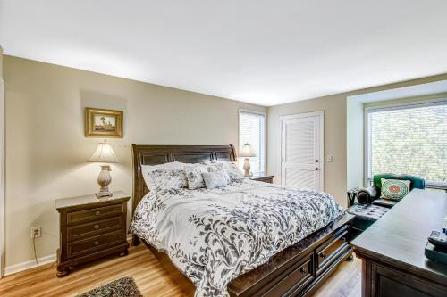 a bedroom with a bed and a desk and a window at Pelican Watch 1380 in Seabrook Island