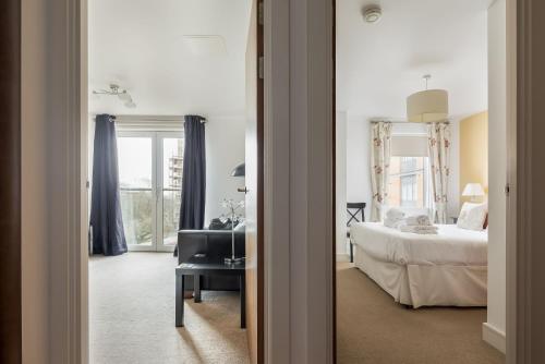 a bedroom with a bed and a desk and a mirror at Vista in Poole