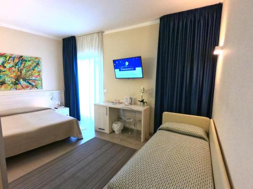 Una cama o camas en una habitación de Hotel Olympic