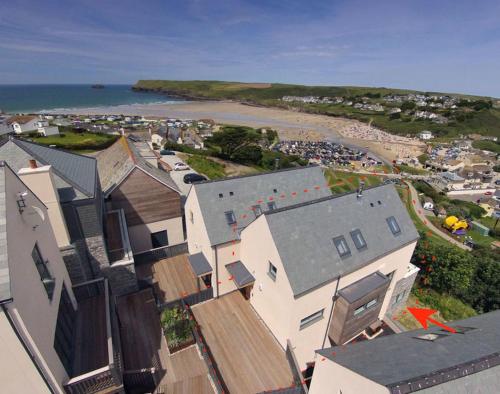 an aerial view of a town with houses and a beach at Kellan in Polzeath