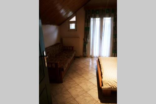 a living room with a couch and a window at Sweet Home in Tríkala