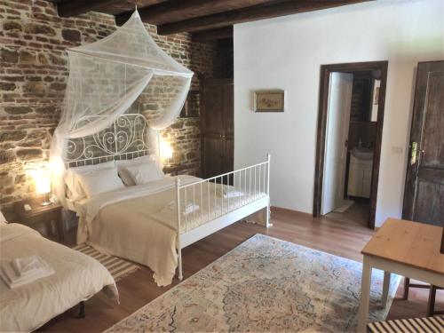 a bedroom with a bed with a netting above it at Casa Marta in Bărcuţ
