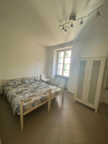 a bedroom with a bed and a window at Ostello Voltaggio in Voltaggio