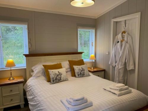 a bedroom with a bed with towels on it at Hollicarrs - Sunflower Lodge in York
