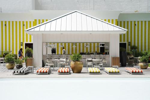 a pavilion with tables and chairs in a building at Dua Miami, Autograph Collection in Miami