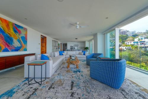 a living room with a dog standing in the middle at Maxwell Residences at Indah in Puerto Vallarta