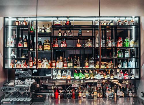 a bar filled with lots of bottles of alcohol at Hotel 93 Luxury Suites by Preferred in Bogotá