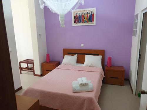 um quarto com uma cama com duas toalhas em Cactus Guest House em Cidade Velha