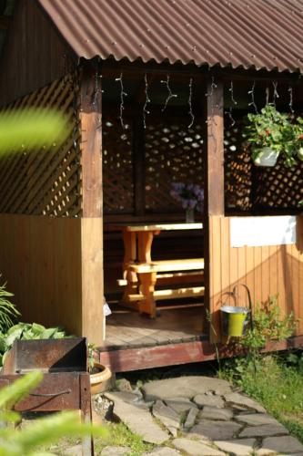 a wooden gazebo with a bench on it at Котедж з неймовірними краєвидами, Карпатський Чан DREAM, Чан Джакузі in Slavske
