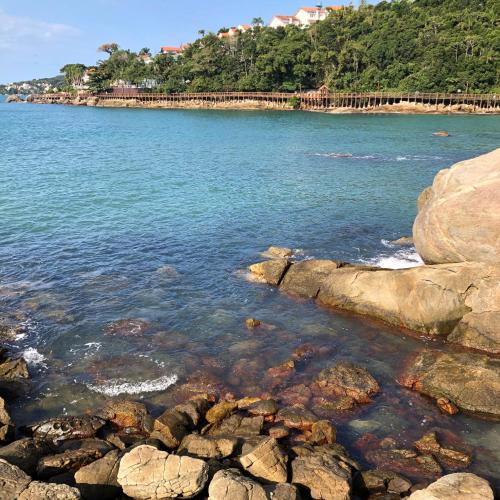 a view of a beach with rocks in the water at Pousada Kia Ora Bombinhas in Bombinhas