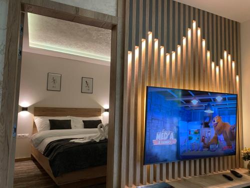 a bedroom with a bed and a tv on a wall at Matrix in Tatranská Lomnica