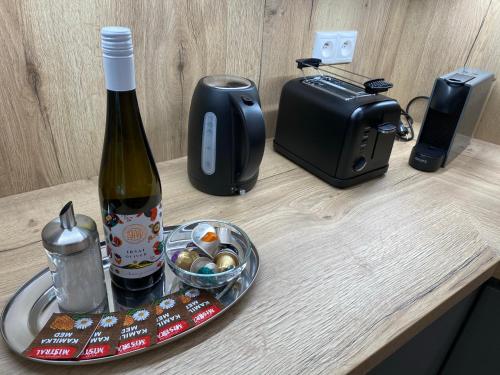 a table with a bottle of wine and a toaster at Matrix in Tatranská Lomnica