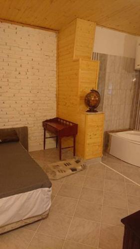 a bedroom with a bed and a table in a room at Majorka in Balatonfenyves