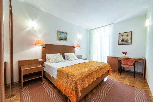 a hotel room with a bed and a desk at Villa Lia in Dubrovnik