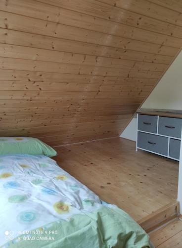 a bedroom with a bed and a wooden ceiling at art-house 4 Attic Apartment in Děčín