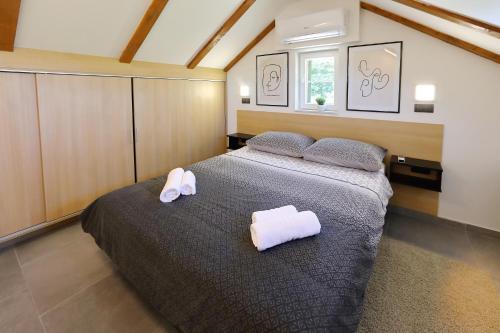 a bedroom with a bed with two towels on it at Stone Diamond in Zadar