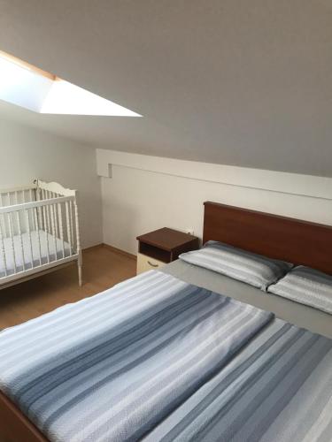 a bedroom with a bed and a crib at Apartment Marie in Vrsi