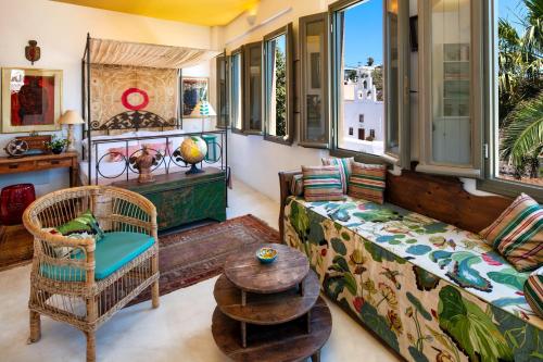 a living room with a couch and a table at Hiraeth Santorini in Megalokhori