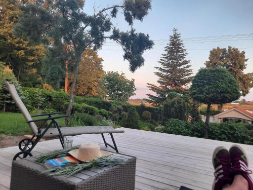 a person standing on a patio with their feet on a bench at Apartamenty Sielanka in Olecko