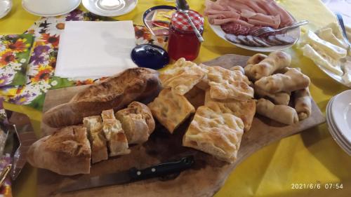a plate of bread and pastries on a table at Cascina Boschetto in Saliceto