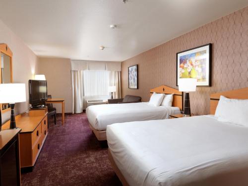 A bed or beds in a room at Crystal Inn Hotel & Suites - West Valley City