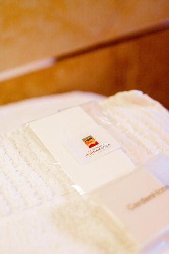 a white book sitting on top of a bed at Colores de Purmamarca in Purmamarca