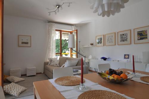 a living room with a table with a bowl of fruit on it at Sole & Querce Apartments- Bike Friendly with garage in Lanciano