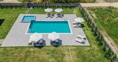 an overhead view of a swimming pool with chairs and umbrellas at Katerina's Resort in Sarti