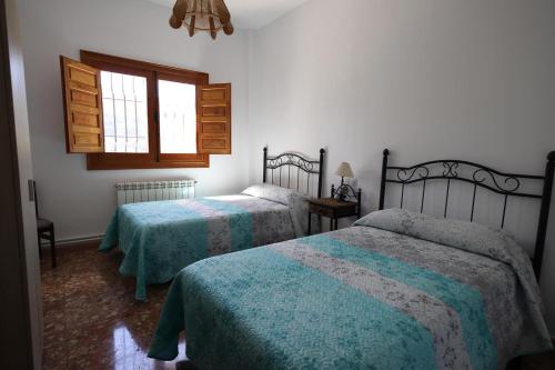 A bed or beds in a room at VILLA FORASTERA