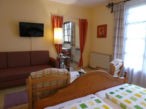 a living room with a bed and a couch at Haus Daheim in St. Wolfgang