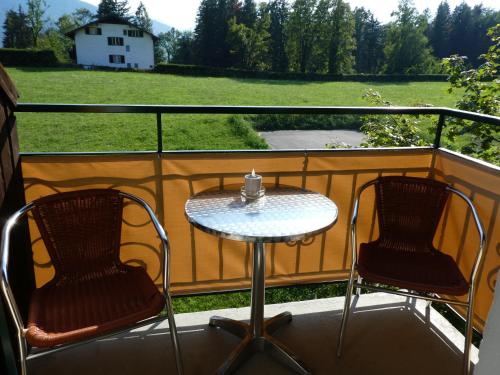 a table and two chairs on a balcony at Haus Daheim in St. Wolfgang