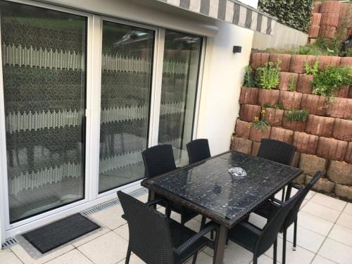 a black table and chairs on a patio at Olive in Uhldingen-Mühlhofen