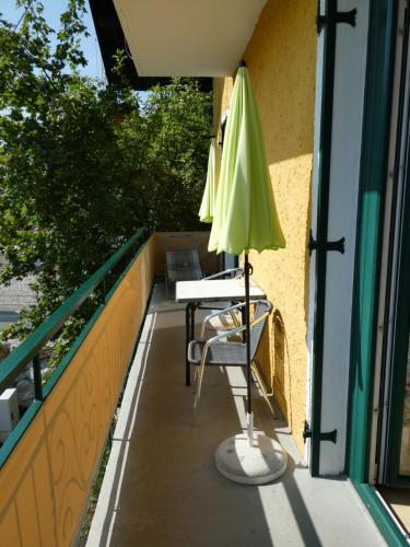 an umbrella and a table on a balcony at Haus Daheim in St. Wolfgang