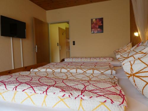 a bedroom with a large bed with a comforter at Haus Daheim in St. Wolfgang