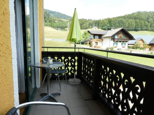 a balcony with a table and a view of a house at Haus Daheim in St. Wolfgang