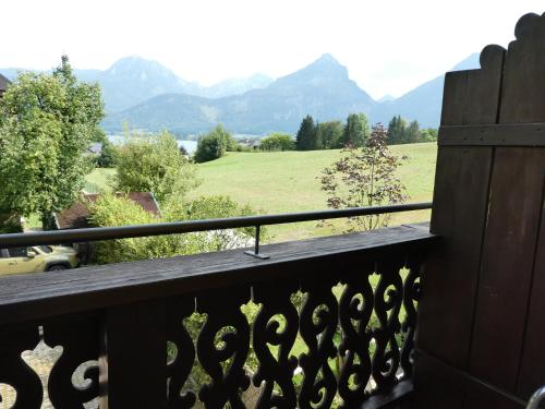 a balcony with a view of a field and mountains at Haus Daheim in St. Wolfgang