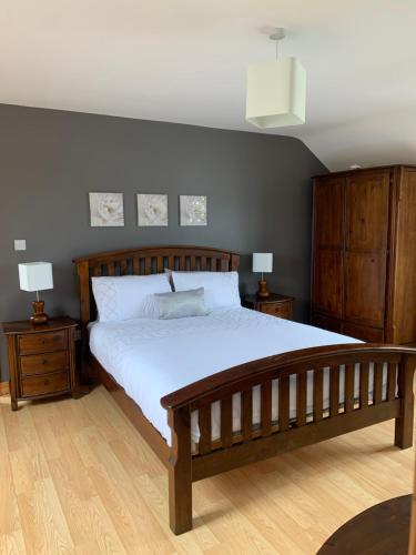 a bedroom with a large bed and two night stands at Wild Atlantic Way House in Achill