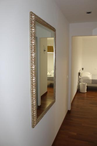 a mirror on a wall in a room with a bed at B&B San Salvo in San Salvo